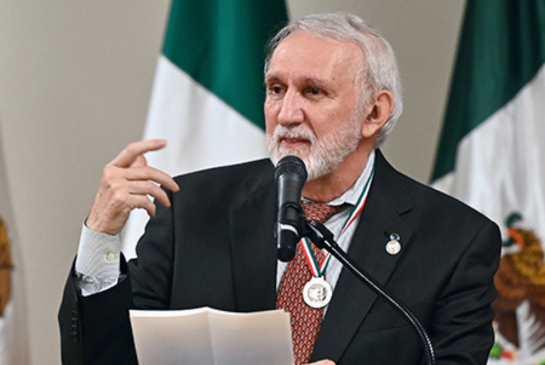 Sergio Aguilar-Gaxiola speaks at podium.